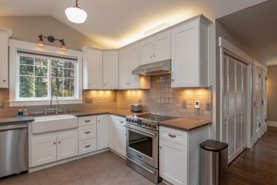 Bright and spacious kitchen with white cabinetry and sleek appliances.