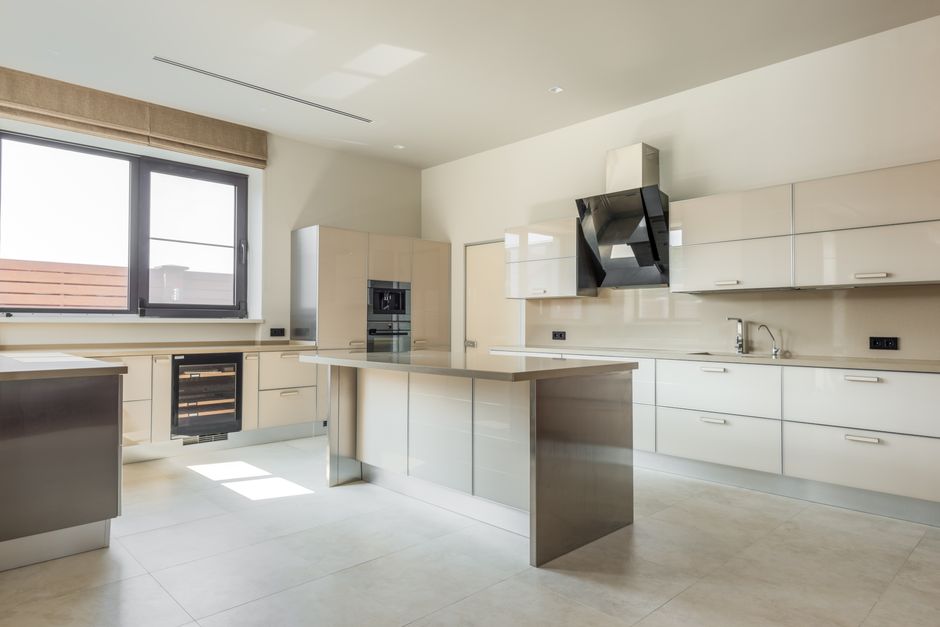 A bright, spacious kitchen featuring minimalist design and modern appliances.