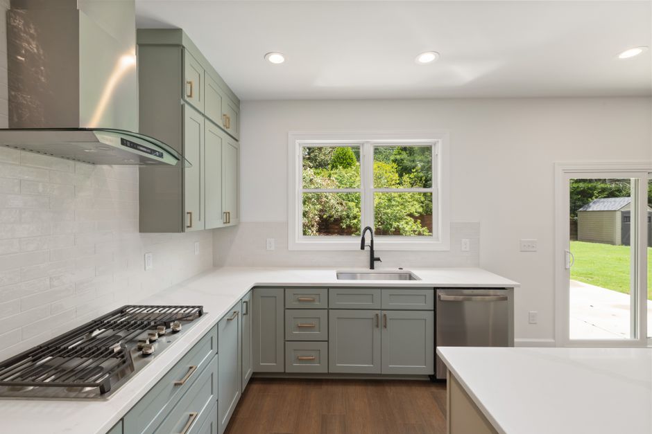 Spacious modern kitchen with sleek cabinets, stainless steel appliances, and a view of the outdoors.