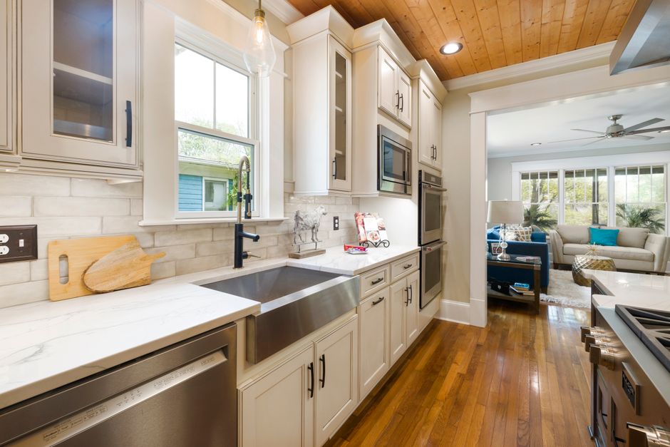 A modern kitchen with natural light, wooden accents, and sleek appliances