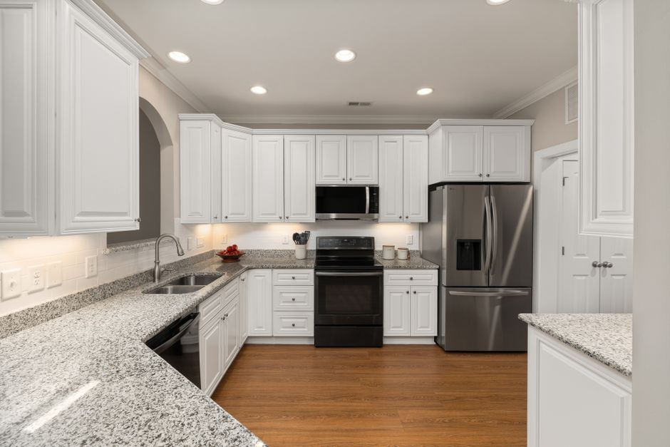 Sleek kitchen with stainless steel appliances and granite countertops, perfect for modern homes.