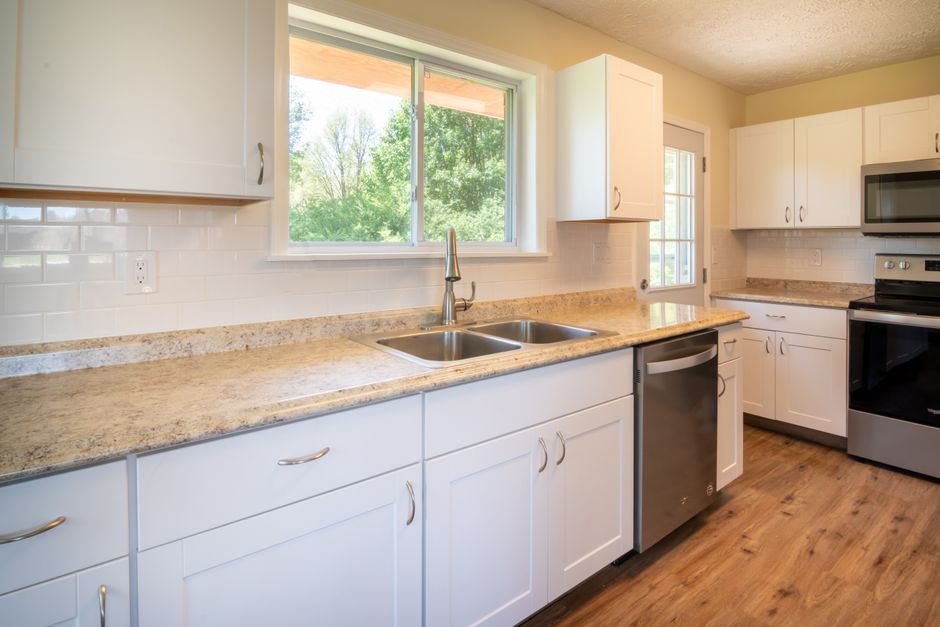 Bright and spacious kitchen with modern appliances and wooden flooring.